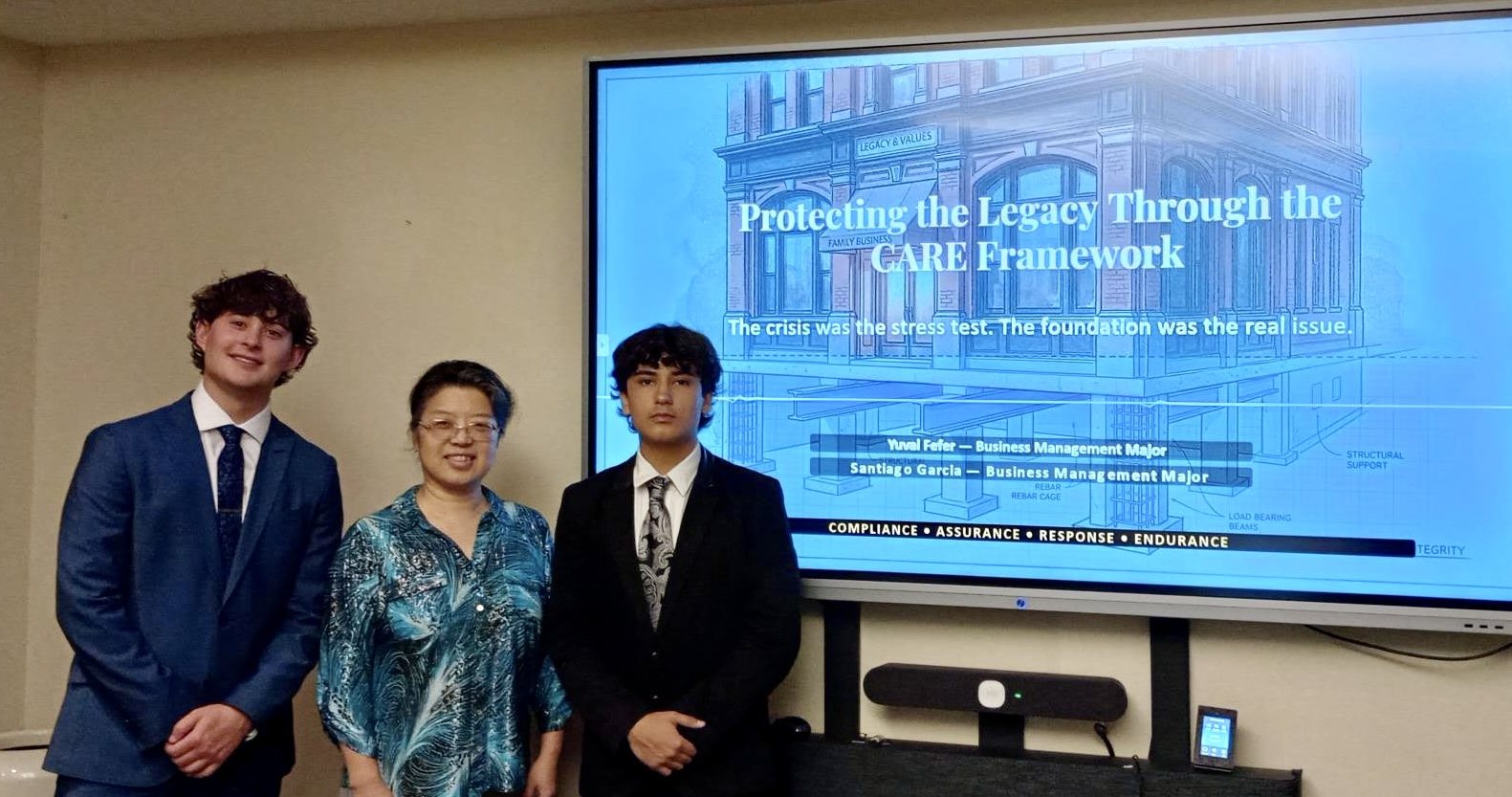 Yuval and teammate Santiago Garcia with their advisor, Dr. Baiyun Gong, in front of their final slide