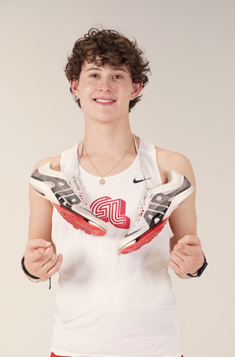 Yuval in his Fair Lawn track uniform holding his spikes
